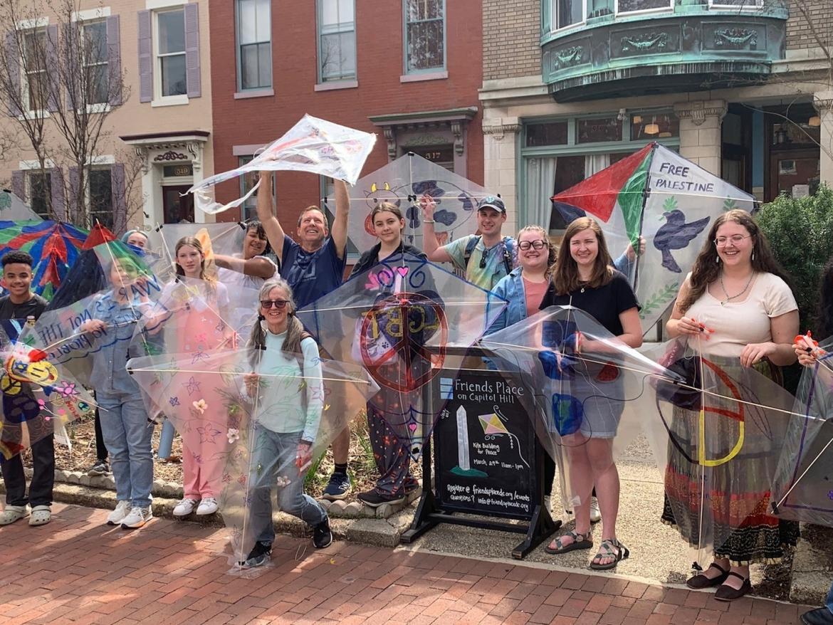 People gathered in front of Friends Place with kites